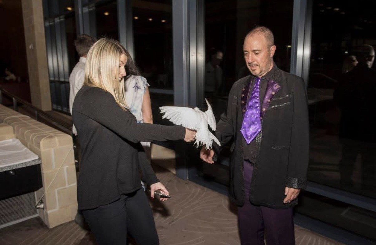 Amazing Mr Twist performing dove magic at an evening corporate event